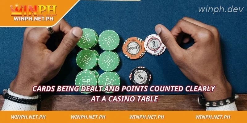Cards being dealt and points counted clearly at a casino table